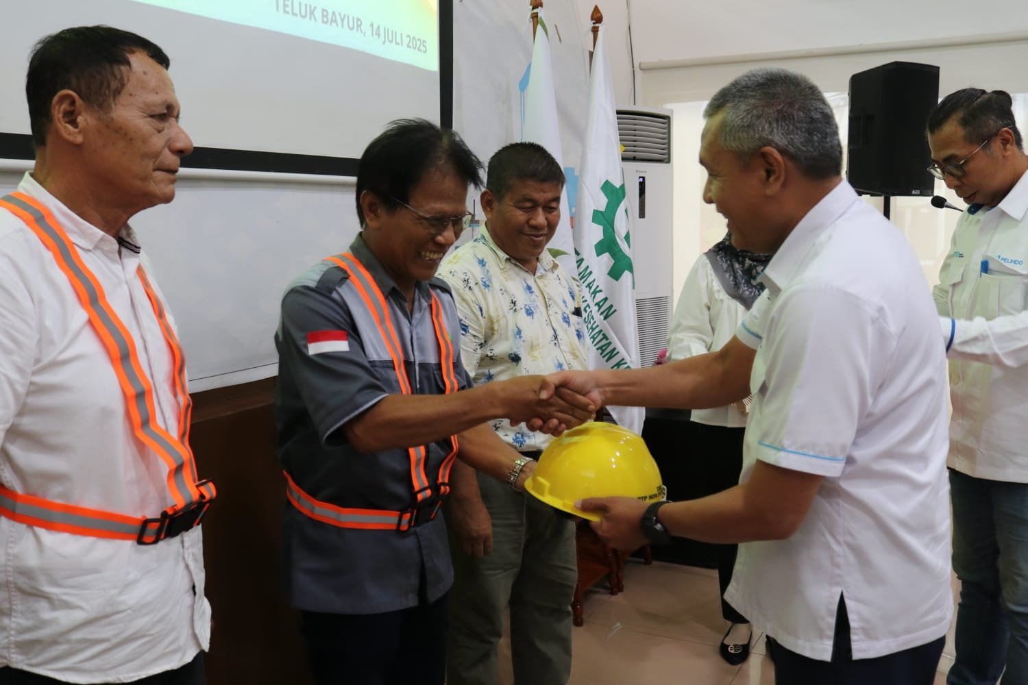 BM PTP Nonpetikemas Cabang Teluk Bayur, Fauzi, menyerahkan APD kepada 40 TKBM sebagai aksi TJSL Peduli K3